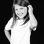 child, girl, smile, white_shirt, long_hair, black_background, portrait, happy, posing, young, cute, casual, standing, female, monochrome, studio, confident, hand_on_hip, playful, youth