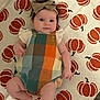 Baylee joined the competition — help win amazing prizes! baby, infant, headband, bow, colorful_clothing, romper, pumpkin_pattern, rug, floor, cute, child, indoors, person, skin, legs, arms, smile, fall_theme, decor, young_child