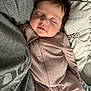 Baylee is registered to the contest to win money with this photo: baby, sleeping, onesie, ribbed_clothing, person, gray_shirt, close_up, face, peaceful, infant, soft_lighting, bed, blanket, pink_bottle, cozy, cuddling, child, toddler, portrait, indoor