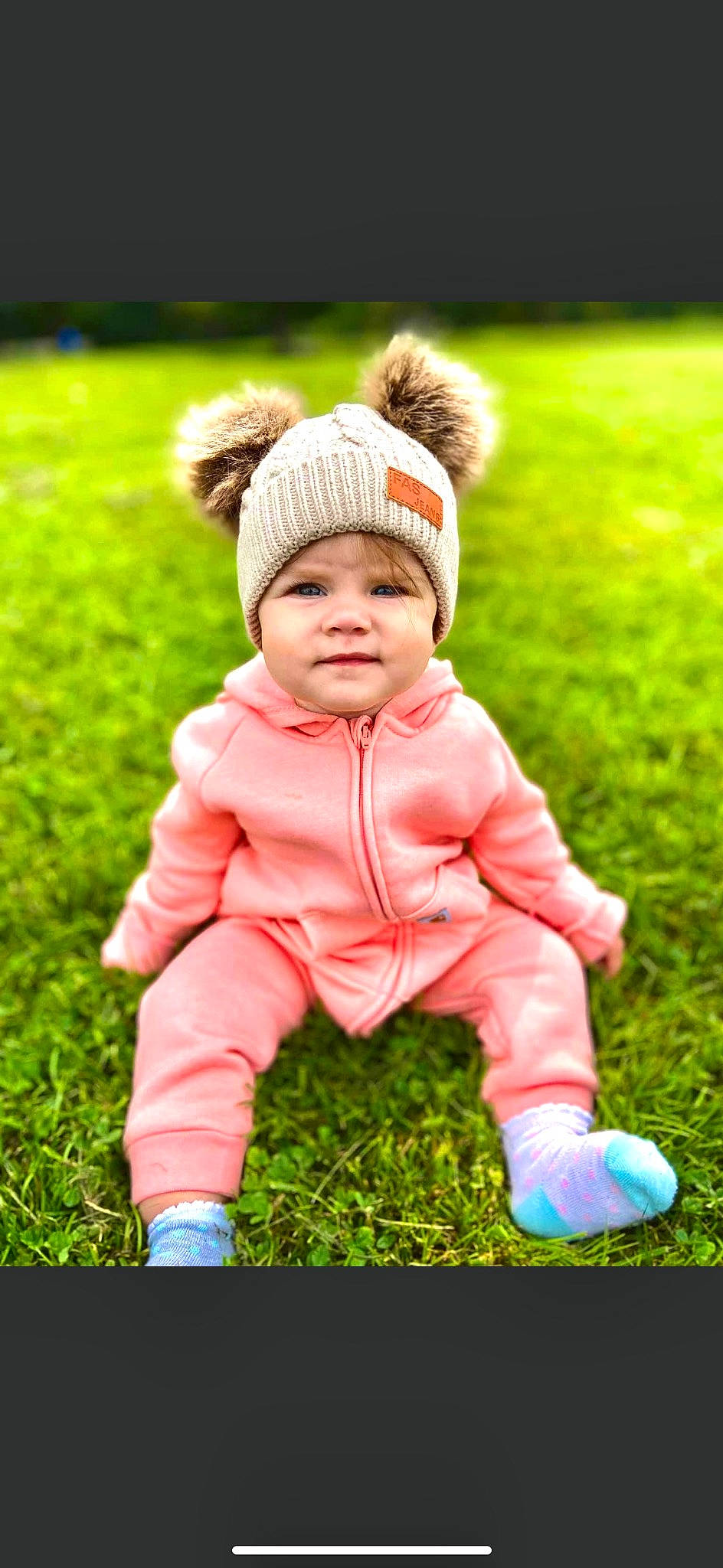 Faye joined the competition — help win amazing prizes! baby, baby_toddler_clothing, beanie, cap, child, eye, flash_photography, fun, gesture, grass, grassland, happy, hat, headwear, people_in_nature, person, plant, recreation, sitting, sleeve