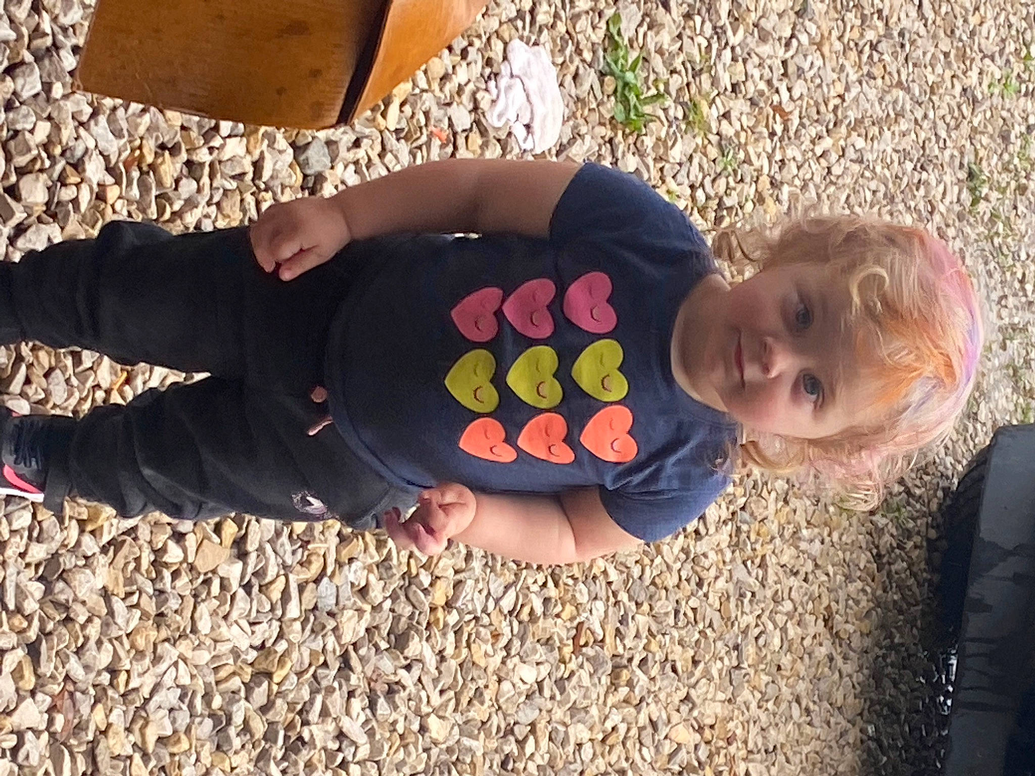 Sophie is registered to the contest to win money with this photo: asphalt, ball, child, foot, fun, gesture, grass, happy, human_leg, knee, leisure, nail, pattern, people_in_nature, person, sitting, soil, thigh, thumb, toddler