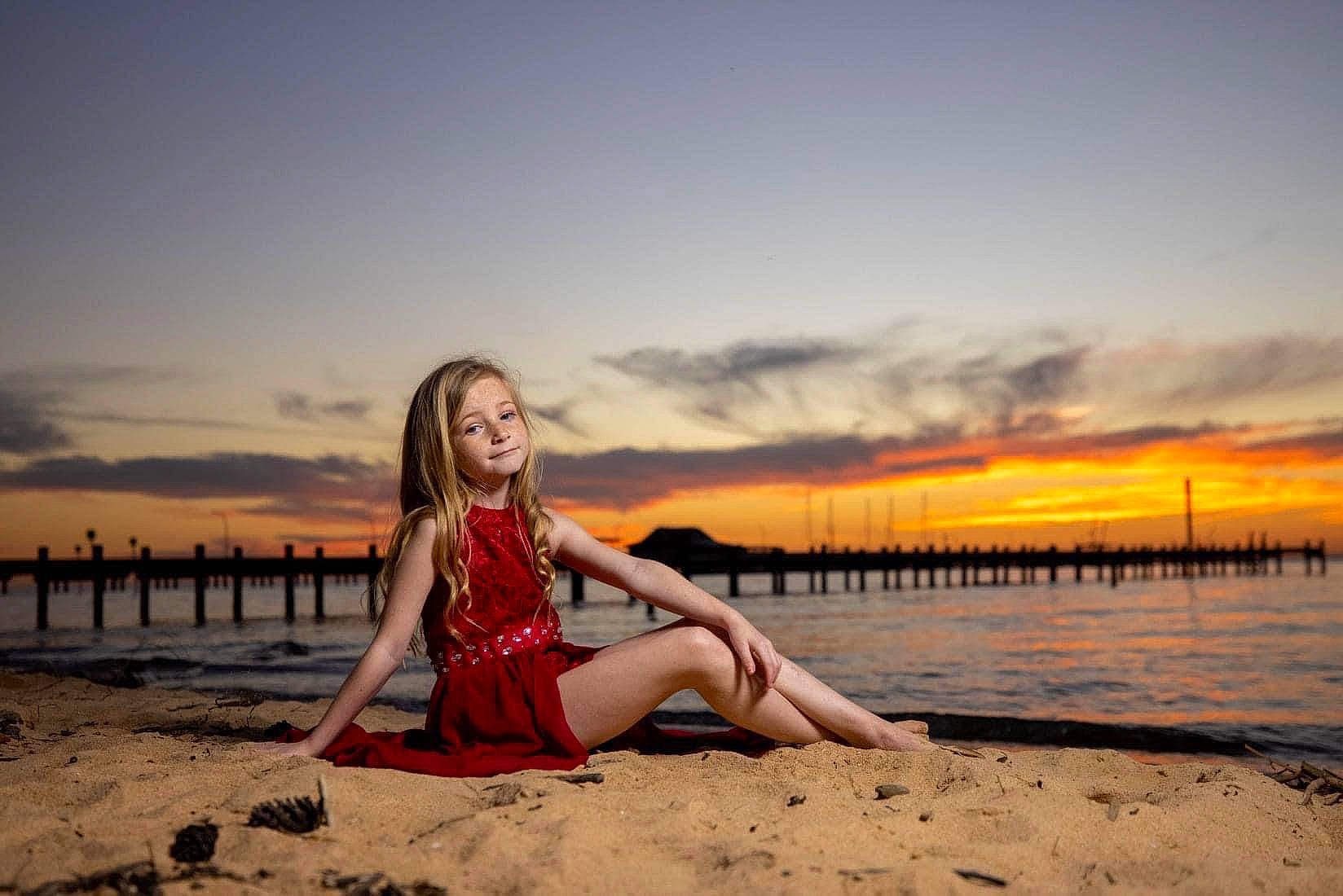 Kylie is registered to the contest to win money with this photo: afterglow, beach, cloud, dress, dusk, flash_photography, hair, hairstyle, hand, happy, human_body, leg, people_in_nature, people_on_beach, person, sky, sunlight, thigh, travel, water