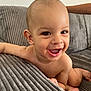baby, child, smiling, happy, couch, indoor, infant, skin, face, eyes, mouth, hand, foot, bare_chest, furniture, texture, young, cute, portrait, natural_light