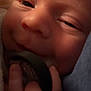 Jensen is registered to the contest to win money with this photo: baby, close_up, face, pacifier, hand, skin, sleepy, infant, newborn, cozy, blanket, soft_light, portrait, cute, child, holding, comfort, expression, young, rest