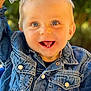 toddler, child, smile, denim_jacket, toy, plush, happy, blue_eyes, face, portrait, outdoor, greenery, cute, baby, joyful, clothing, person, close_up, sitting, playful