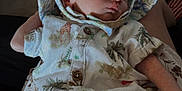 Kylo is registered to the contest to win money with this photo: baby, sleeping, infant, hat, clothing, person, indoor, hand, fabric, pattern, plush_toy, furniture, soft_lighting, face, peaceful, cute, holding, safari_print, newborn, resting