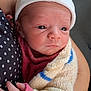 newborn, baby, infant, hat, knitted_sweater, wrapped, cradled, hand, polka_dot, clothing, person, closeup, skin, cute, young, portrait, indoor, warm, soft, serene