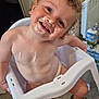 Kurtys participe au concours pour gagner de l'argent avec cette photo : toddler, child, high_chair, yogurt, smiling, curly_hair, face_paint, bare_chest, sandals, indoor, floor, plastic_chair, happy, messy, food, kitchen, person, cute, playful, milk_carton
