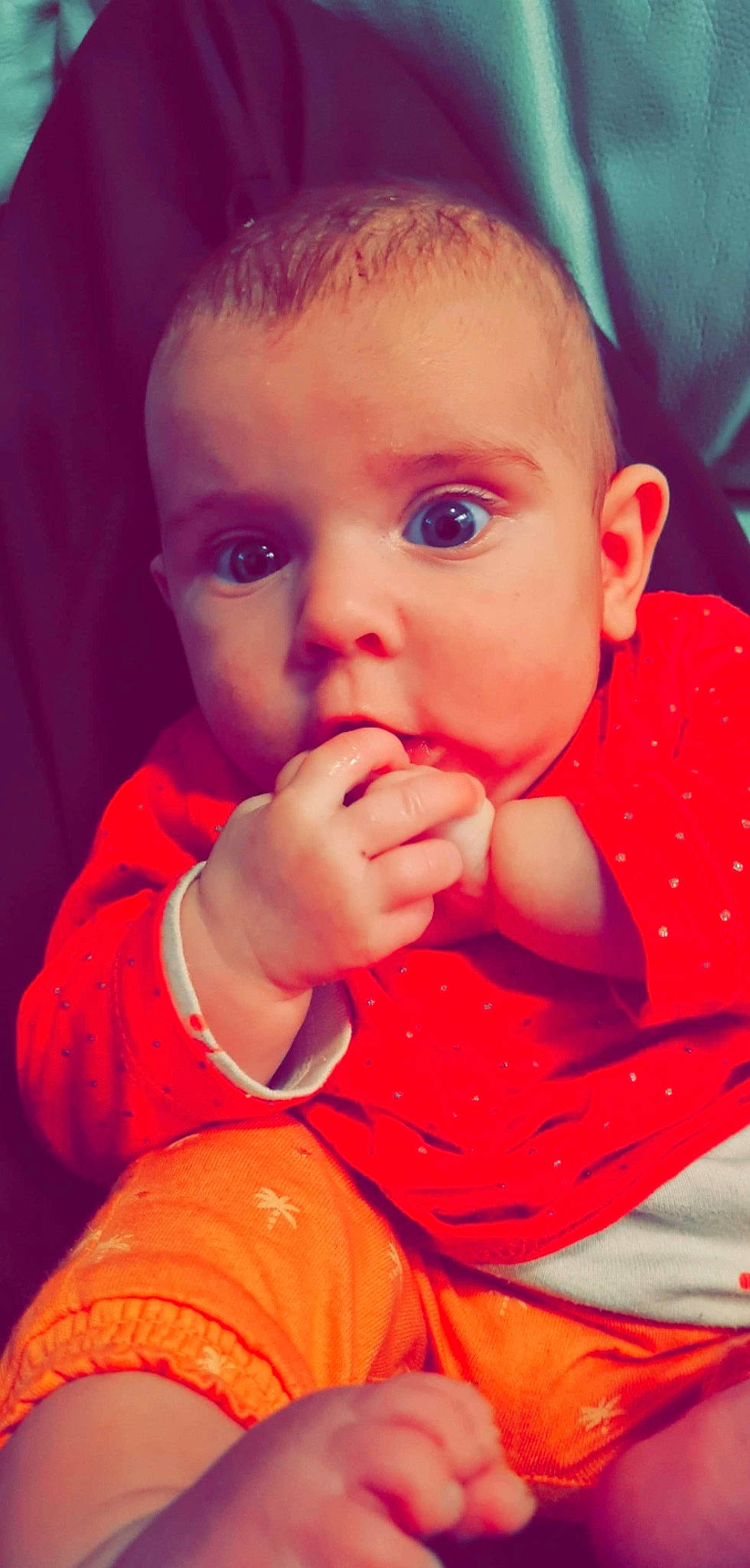 Ashley participe au concours pour gagner de l'argent avec cette photo : baby, baby_toddler_clothing, cheek, child, close_up, eyelash, finger, gesture, happy, iris, lip, mouth, nail, neck, nose, orange, person, skin, sleeve, thumb