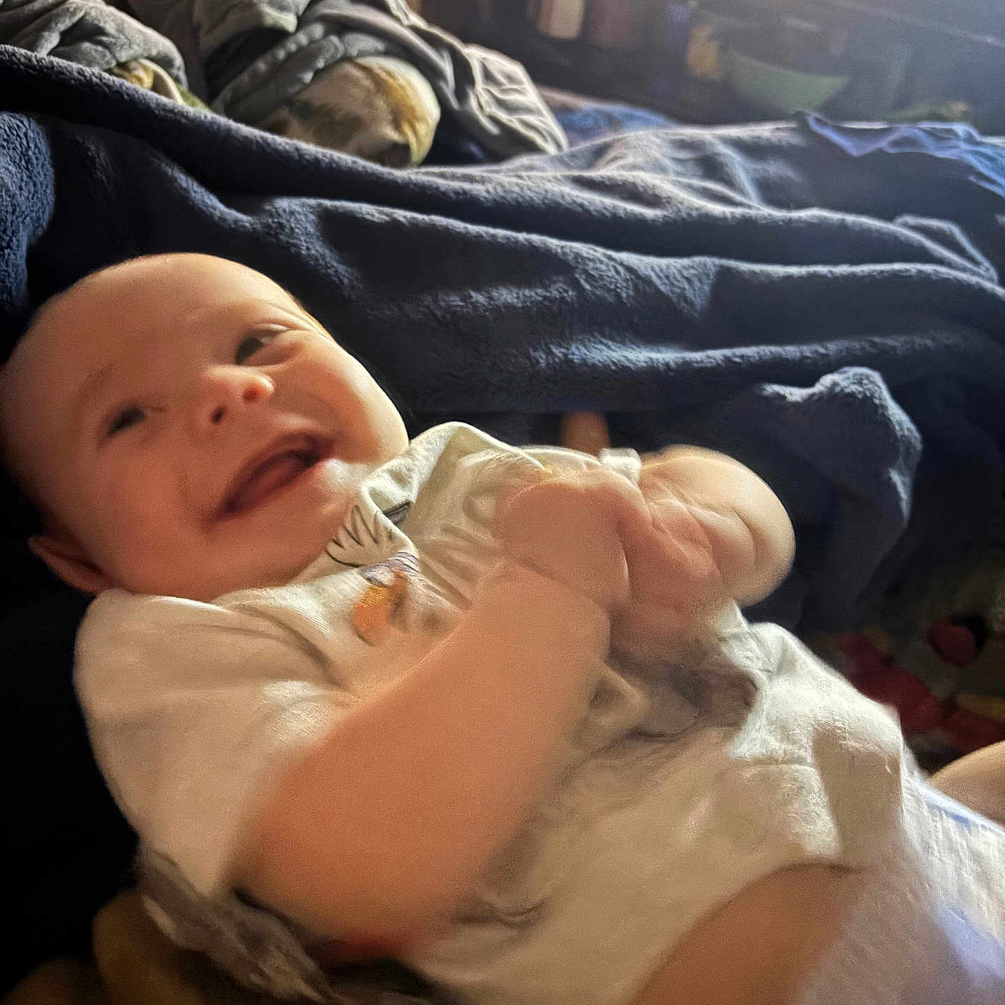 Zayden is registered to the contest to win money with this photo: baby, smiling, infant, happy, blanket, bed, clothing, indoors, light, window, face, person, child, cute, joyful, young, portrait, soft, warm, cozy