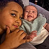 Zayden joined the competition — help win amazing prizes! baby, child, siblings, smile, happy, couch, bib, curly_hair, face, hand, infant, portrait, indoor, skin, clothing, expression, cute, toddler, cozy, family