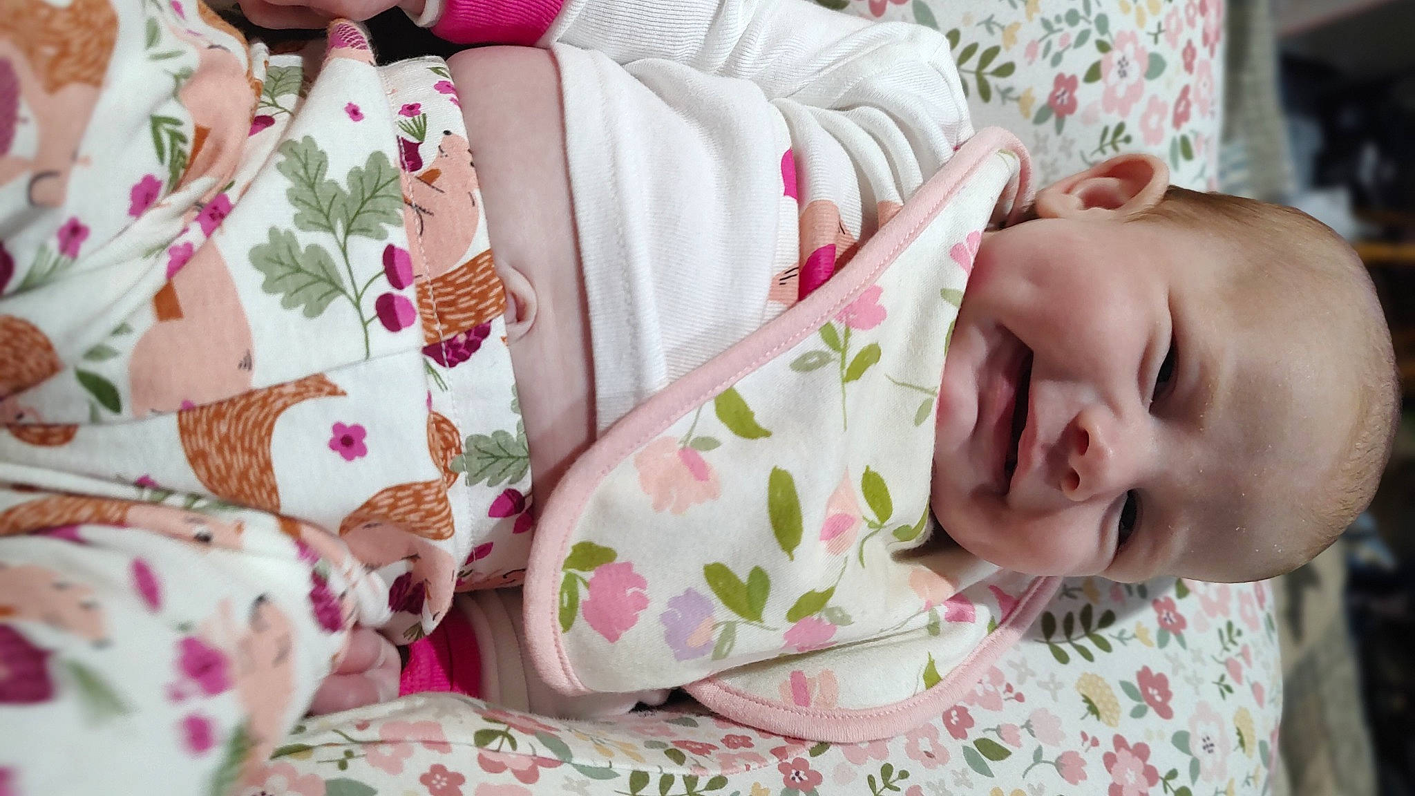 Arabella is registered to the contest to win money with this photo: baby, baby_toddler_clothing, bedding, cheek, child, comfort, eyelash, hand, happy, linens, pattern, person, pink, product, room, rose, skin, sleeve, smile, textile