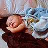 Corey is registered to the contest to win money with this photo: baby, newborn, sleeping, infant, portrait, bed, blanket, pillow, cozy, indoors, resting, peaceful, face, closed_eyes, light_skin, text_overlay, bedding, snuggled, nap, home