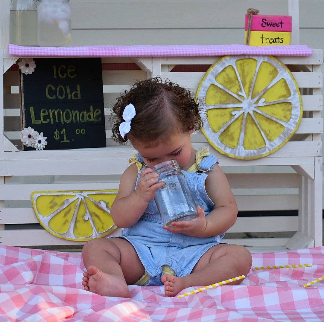 Ellie is registered to the contest to win money with this photo: automotive_wheel_system, baby, baby_toddler_clothing, barefoot, child, design, event, foot, fun, happy, lap, pattern, person, product, room, sitting, snapshot, sock, thigh, toddler