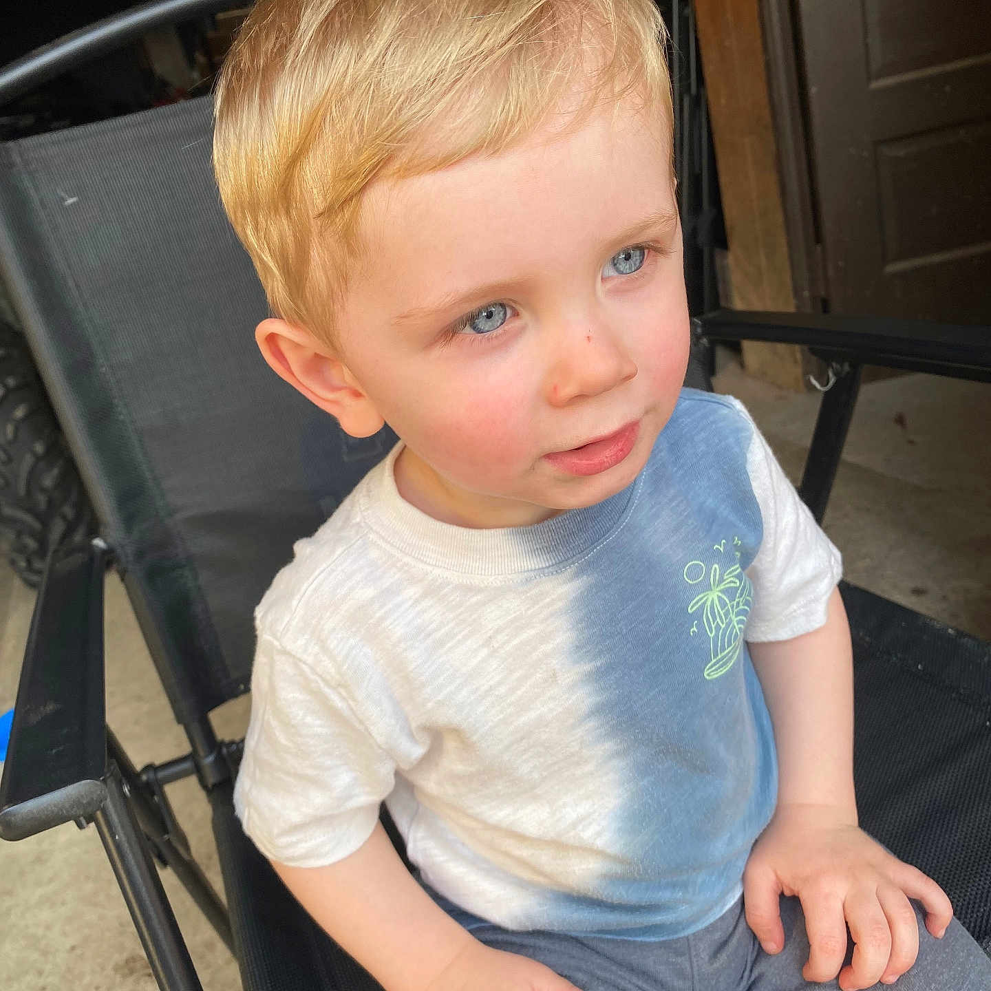 Nolan is registered to the contest to win money with this photo: accessories, baby, bag, blonde, bodypart, chair, clothing, face, finger, furniture, hair, handbag, head, jeans, pants, person, photography, portrait, sitting, t_shirt