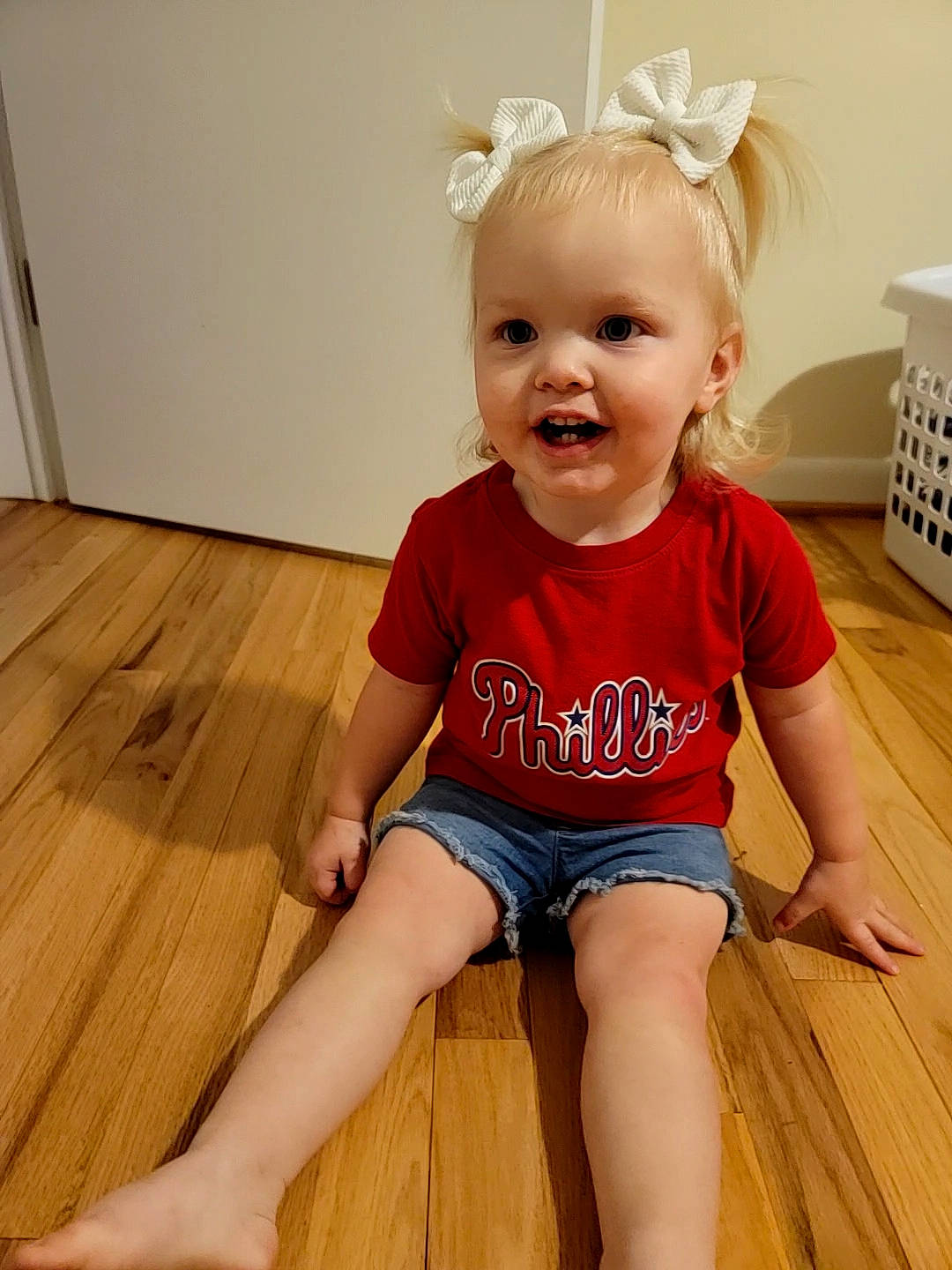 Kynslee joined the competition — help win amazing prizes! baby, baby_toddler_clothing, cheek, floor, flooring, happy, hardwood, human_leg, joint, knee, neck, person, shoulder, skin, sleeve, smile, t_shirt, thigh, toddler, white