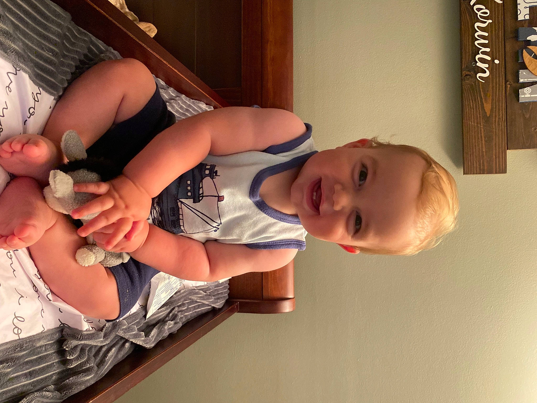 Lochlan is registered to the contest to win money with this photo: arm, baby, child, dress, elbow, finger, foot, fun, gesture, hand, happy, human_leg, joy, knee, nail, organ, person, smile, standing, thigh