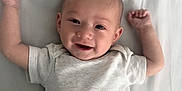 Silviano is registered to the contest to win money with this photo: baby, infant, smiling, lying_down, onesie, arms_up, happy, cute, child, young_baby, skin, face, head, sleepwear, white_background, indoors, portrait, person, newborn, resting