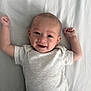 baby, infant, smiling, lying_down, onesie, arms_up, happy, cute, child, young_baby, skin, face, head, sleepwear, white_background, indoors, portrait, person, newborn, resting