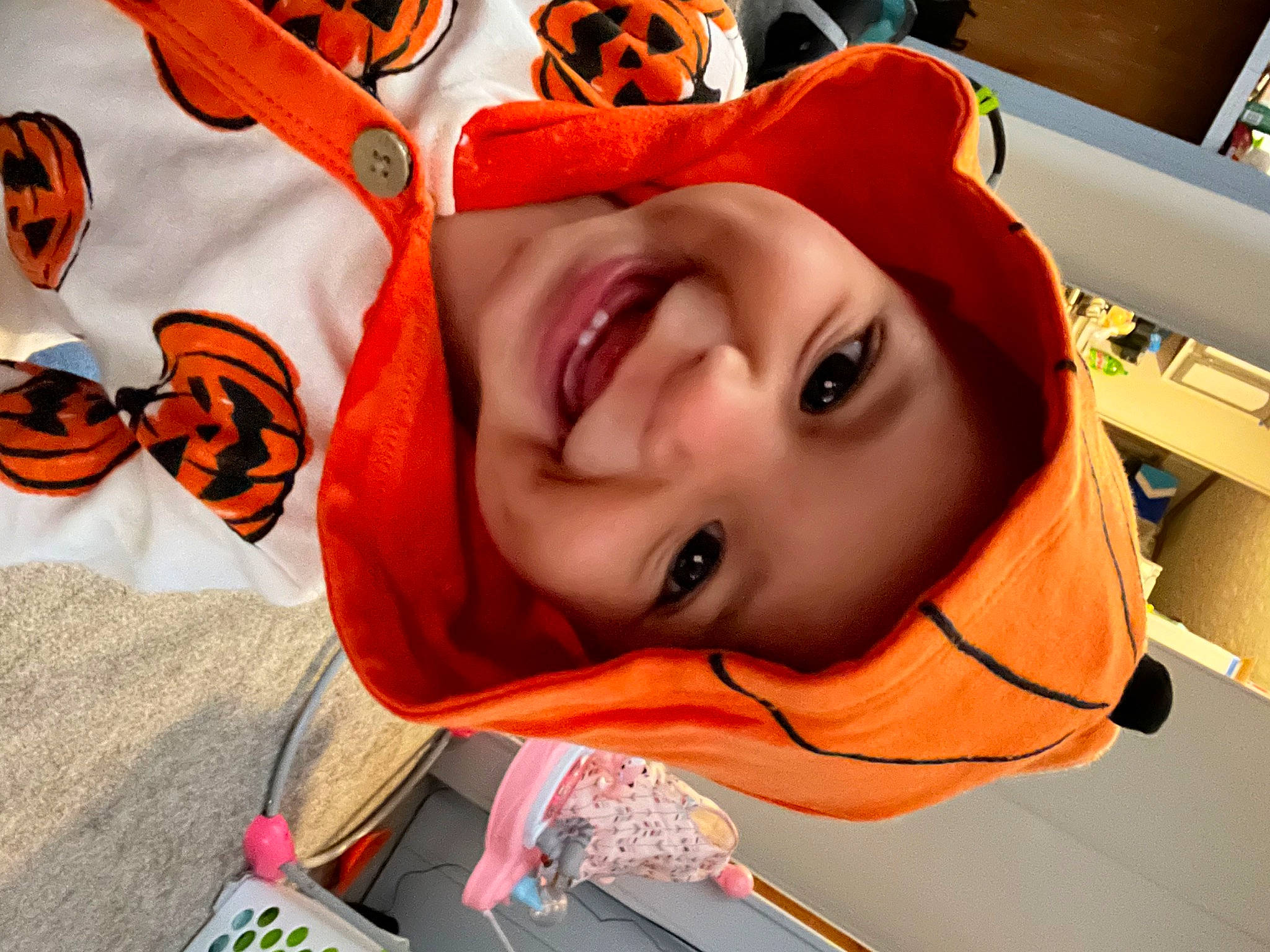 Kiara is registered to the contest to win money with this photo: baby, cheek, child, comfort, cool, eye, eyebrow, eyelash, fun, happy, head, headgear, headwear, joy, mouth, nose, orange, person, personal_protective_equipment, sleeve