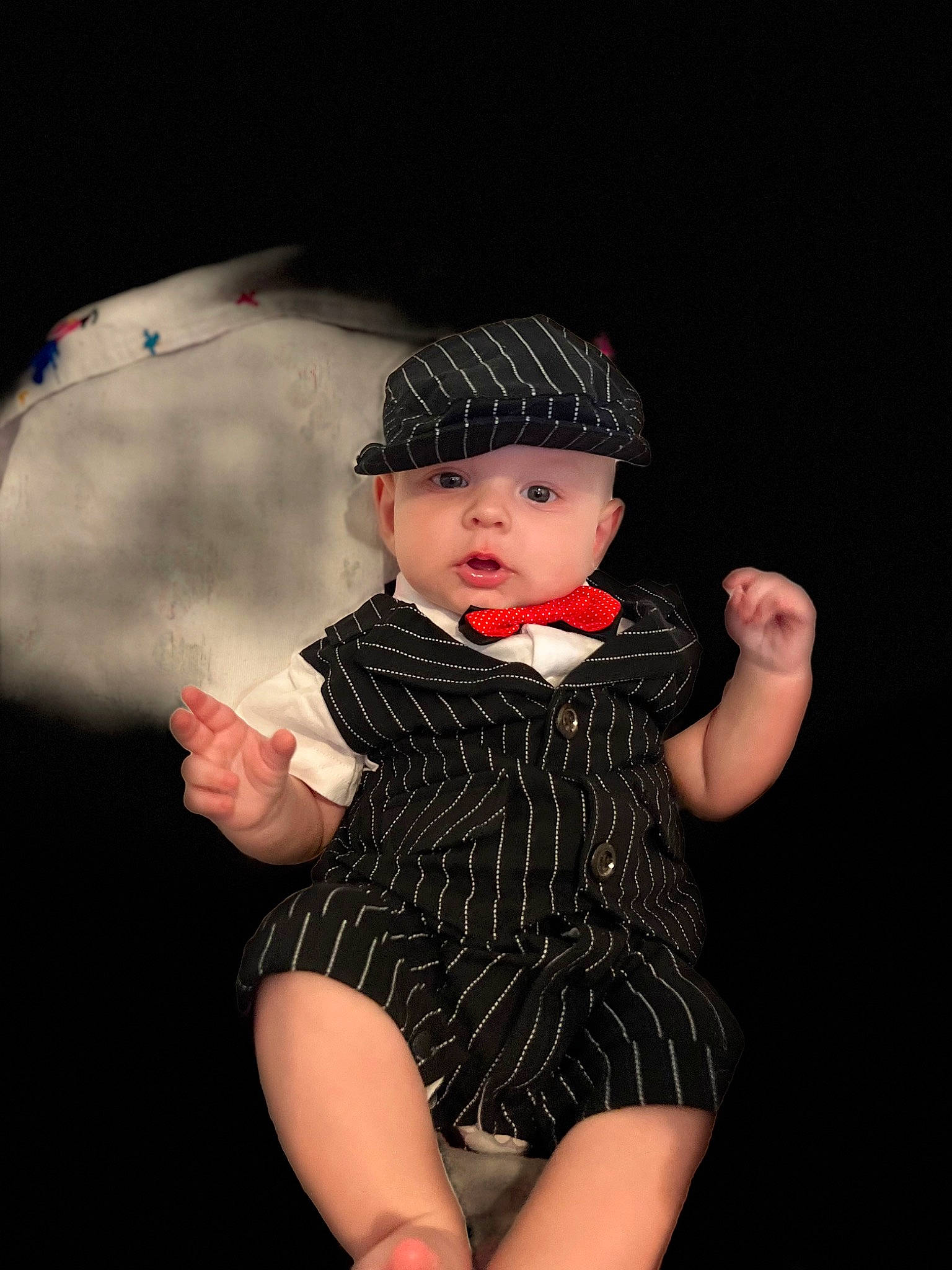 Rowen is registered to the contest to win money with this photo: baby, baby_toddler_clothing, black_hair, cap, darkness, fashion_accessory, fashion_design, flash_photography, foot, hand, hat, headgear, headwear, human_leg, pattern, person, personal_protective_equipment, sleeve, sun_hat, thigh