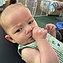 Kingston joined the competition — help win amazing prizes! baby, infant, thumb_sucking, green_striped_clothing, indoor, furniture, baby_gate, carpet, child, cute, person, portrait, young, head, face, skin, arm, sleeveless, expression, home