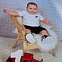 black_shorts, brick_wall, carpet, celebration, child, cute, first_birthday, floor, happy, indoor, nike_logo, number_one, portrait, smiling, sneakers, toddler, toy_truck, white_fur, white_shirt, wicker_chair