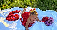 Eleanor is registered to the contest to win money with this photo: baby, baby_girl, celebration, child, crown, cute, flower_arrangement, flowers, grass, greenery, happy, nature, number_six, outdoor, playful, portrait, red_dress, smiling, sunlight, white_cloth