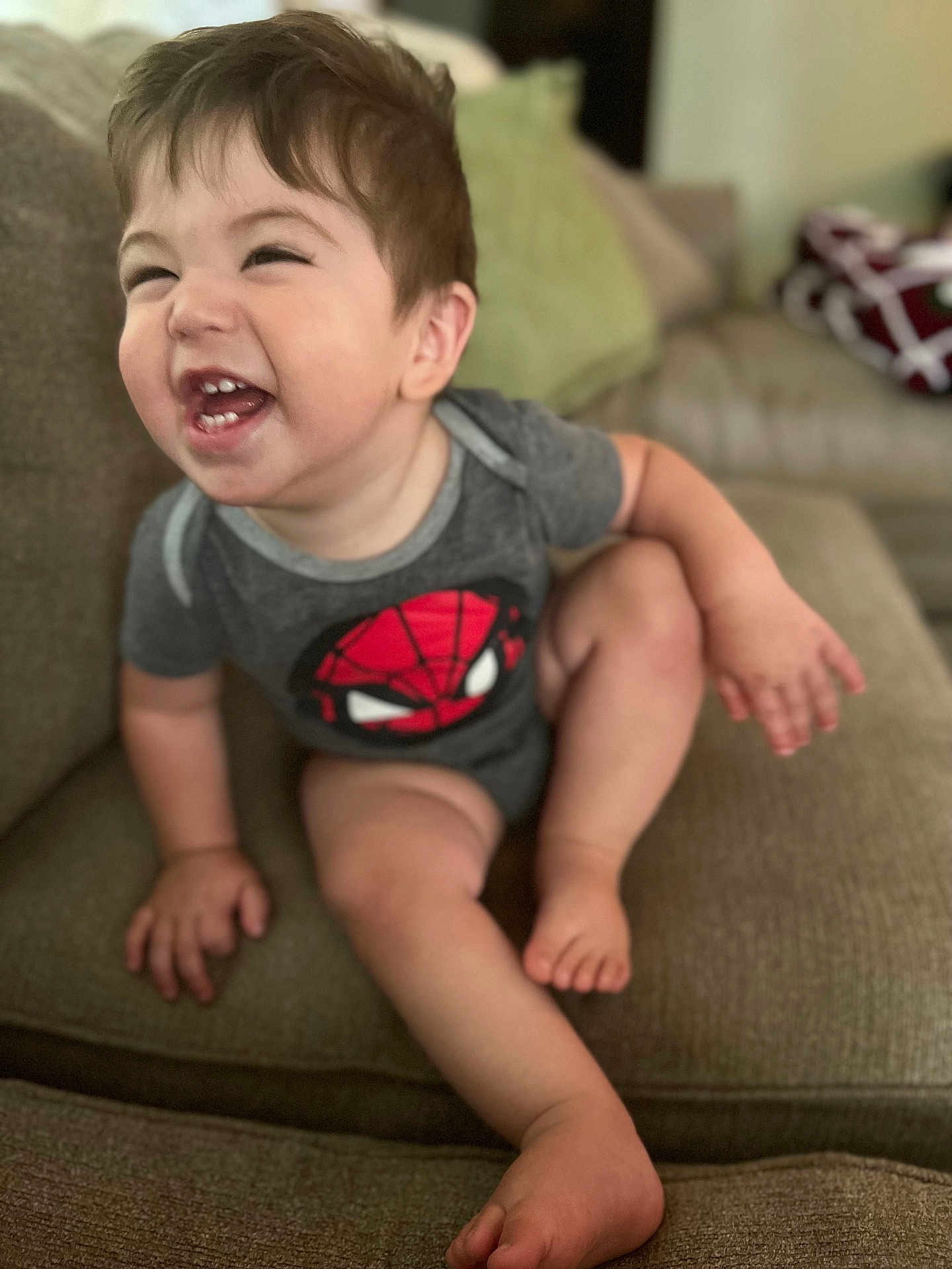 Cruz joined the competition — help win amazing prizes! toddler, child, smiling, laughing, couch, indoor, clothing, onesie, spiderman, happy, person, baby, seat, furniture, cute, skin, head, hair, hand, foot