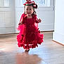 Anaia Amari is registered to the contest to win money with this photo: toddler, child, dress, red_dress, crown, smiling, indoor, wooden_floor, happy, girl, cute, portrait, celebration, headwear, person, floor, bright, natural_light, home, walking
