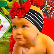 Brytyn is registered to the contest to win money with this photo: baby, blanket, cheerful, child, colorful, crawling, cute, face, festive, green_lights, headband, holiday_decor, indoors, plaid_pattern, portrait, red_bow, soft_texture, striped_band, toddler, young_child