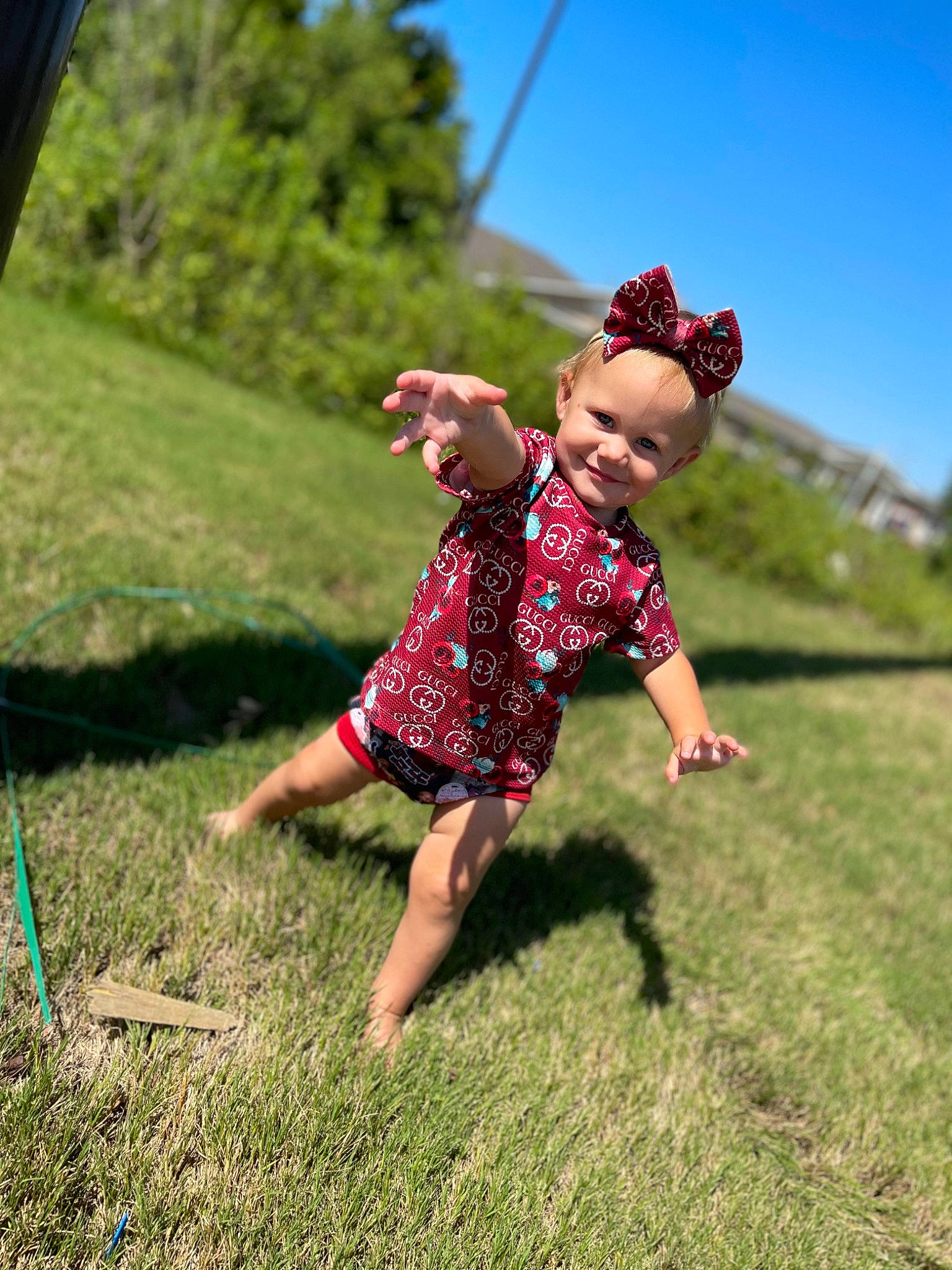 Delilah is registered to the contest to win money with this photo: balance, barefoot, child, fun, gesture, grass, grass_family, grassland, happy, joy, landscape, leaf, leisure, meadow, people_in_nature, person, plant, recreation, sky, t_shirt