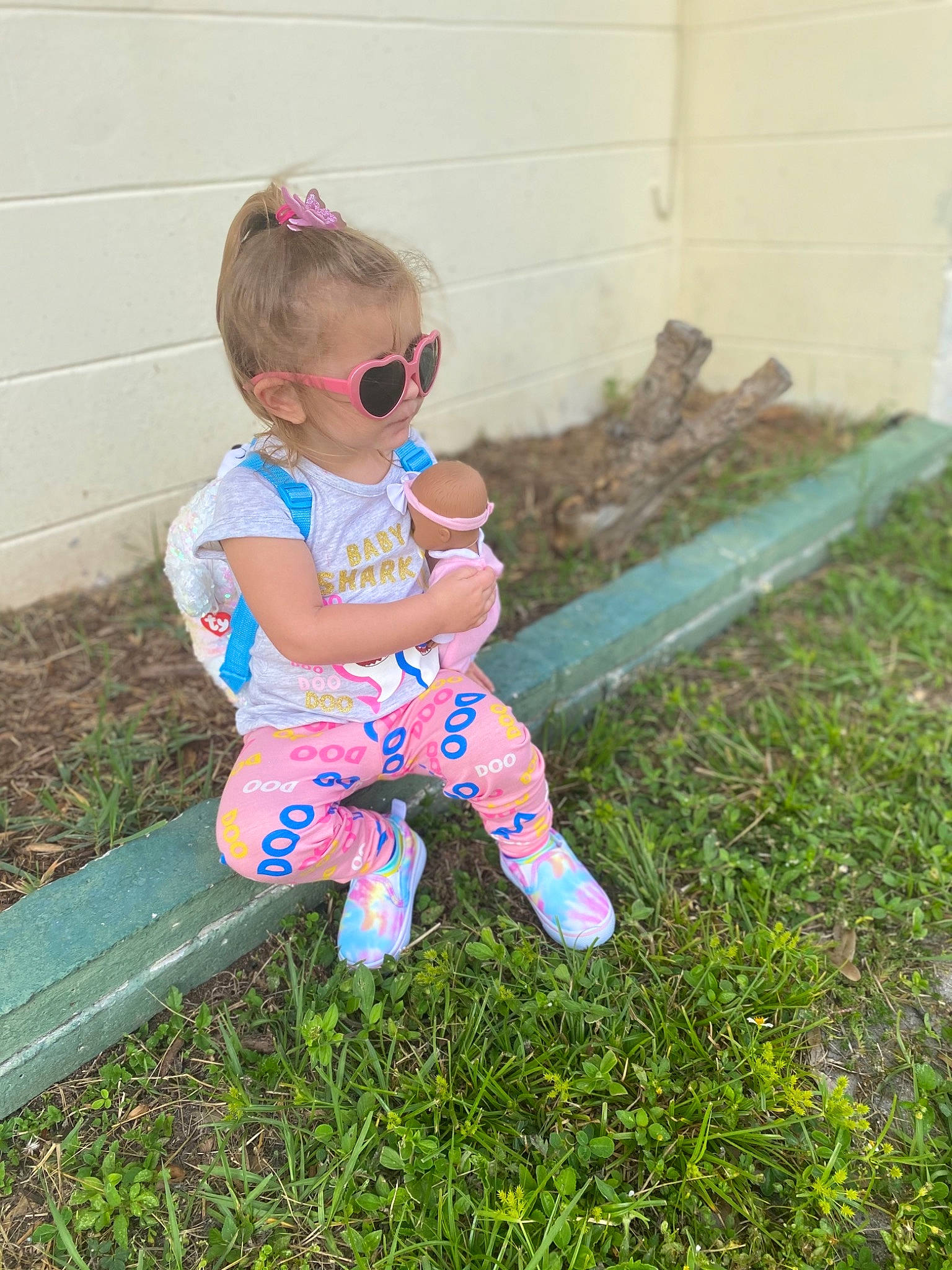 Paizley is registered to the contest to win money with this photo: baby, baby_toddler_clothing, child, electric_blue, eyewear, fun, garden, glasses, goggles, grass, happy, lawn, leisure, magenta, people_in_nature, person, plant, sandal, sitting, sunglasses