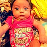 baby, blanket, bow, child, clothing, colorful, cute, expression, fabric, face, headband, indoors, infant, person, pink_clothing, portrait, sitting, sock, soft, young_child