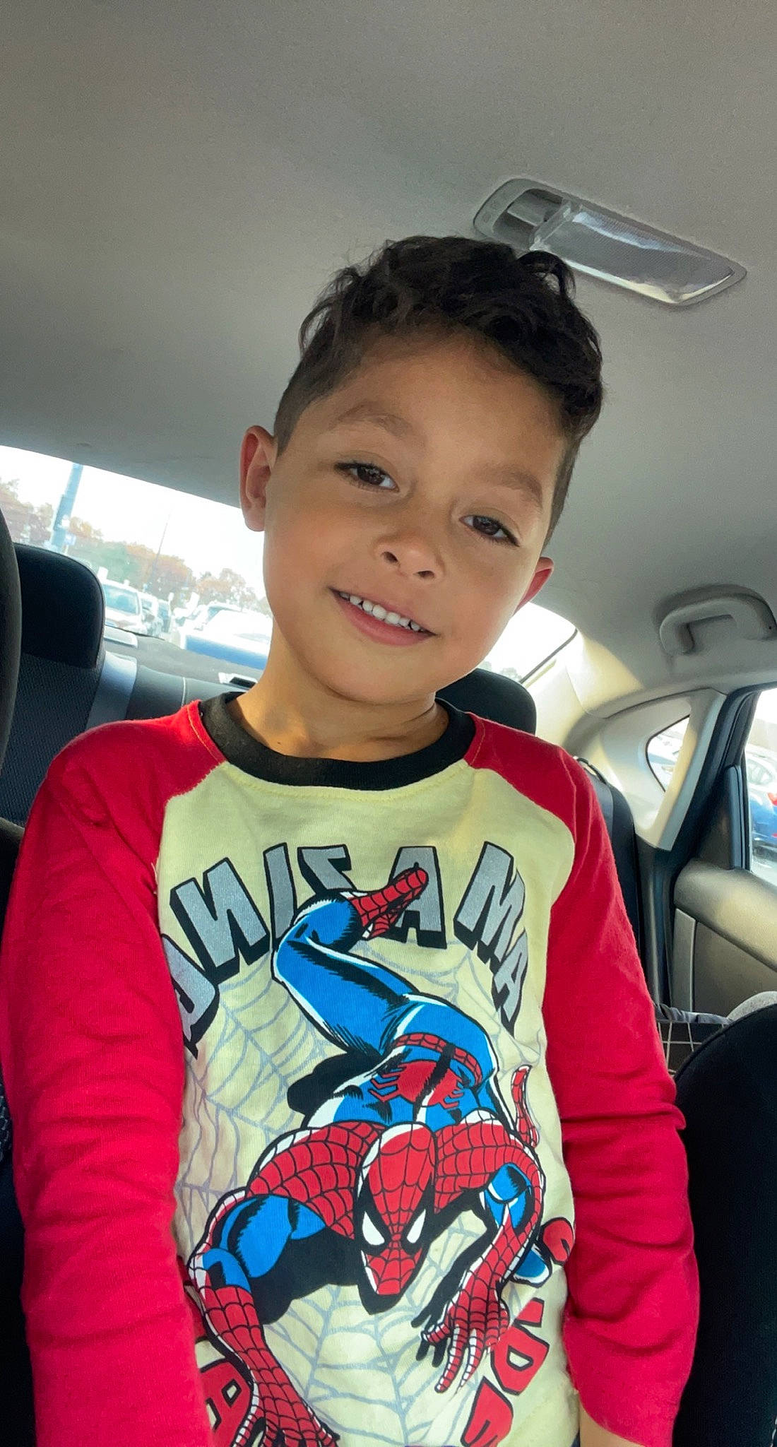 Sebastian is registered to the contest to win money with this photo: automotive_design, automotive_exterior, car, carmine, child, cool, electric_blue, family_car, fictional_character, fun, hairstyle, happy, joy, luxury_vehicle, motor_vehicle, person, sleeve, smile, spider_man, t_shirt