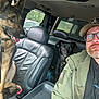 Zeus joined the competition — help win amazing prizes! man, glasses, cap, beard, dog, german_shepherd, black_dog, car_interior, leather_seat, seatbelt, window, trees, daylight, pet, animal, portrait, casual_clothing, smile, selfie, vehicle