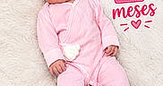 Eva is registered to the contest to win money with this photo: baby, infant, child, portrait, pink_outfit, headband, flower, blanket, lying_down, face, eyes, smiling, hands, shoes, hearts, text_overlay, birthday_milestone, indoor, fashion, cute