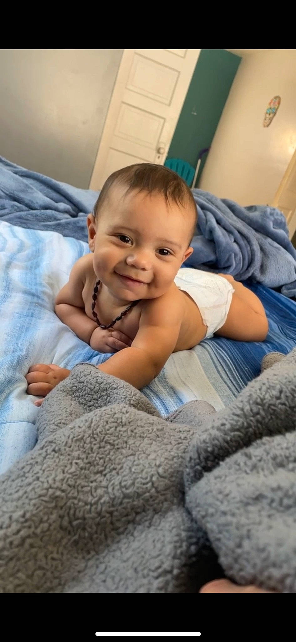 Zyaire is registered to the contest to win money with this photo: baby, baby_toddler_clothing, cheek, child, comfort, facial_expression, finger, floor, flooring, gesture, hand, happy, joy, linens, nose, person, sitting, skin, smile, thumb