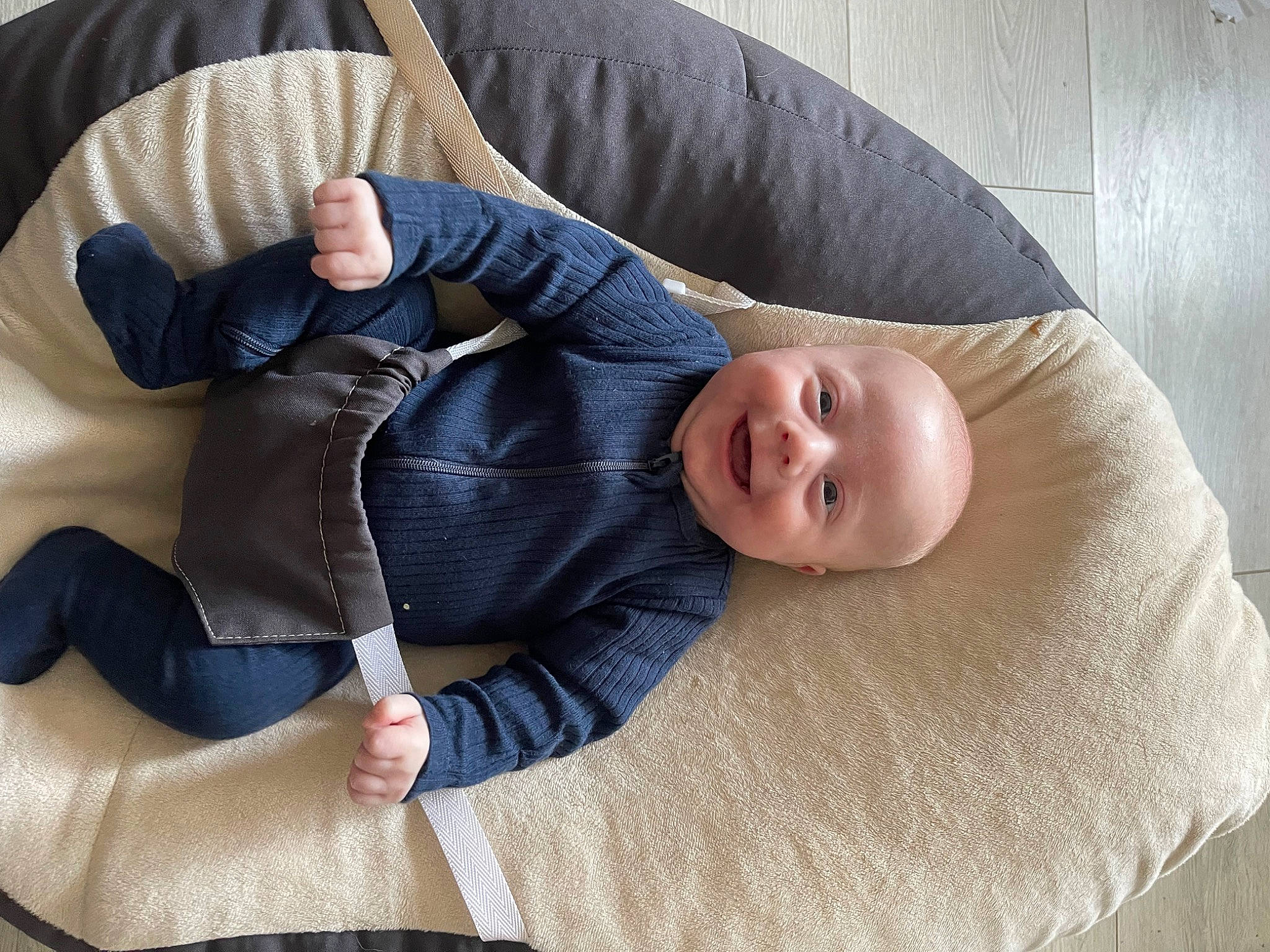 Brody is registered to the contest to win money with this photo: arm, baby, baby_toddler_clothing, child, comfort, couch, finger, furniture, human_leg, joint, joy, knee, lap, leg, linens, person, skin, sleeve, smile, thigh