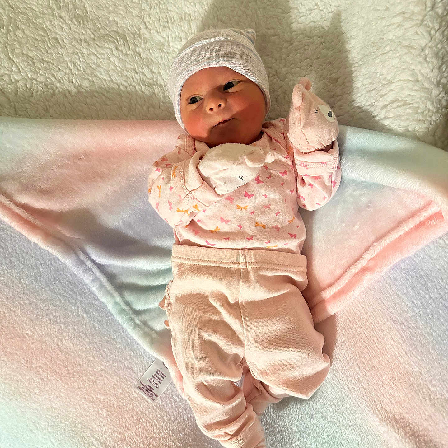 Aurora is registered to the contest to win money with this photo: baby, bed, blanket, bonnet, cap, clothing, face, furniture, glove, happy, hat, head, hosiery, newborn, pants, person, photography, portrait, smile, sock