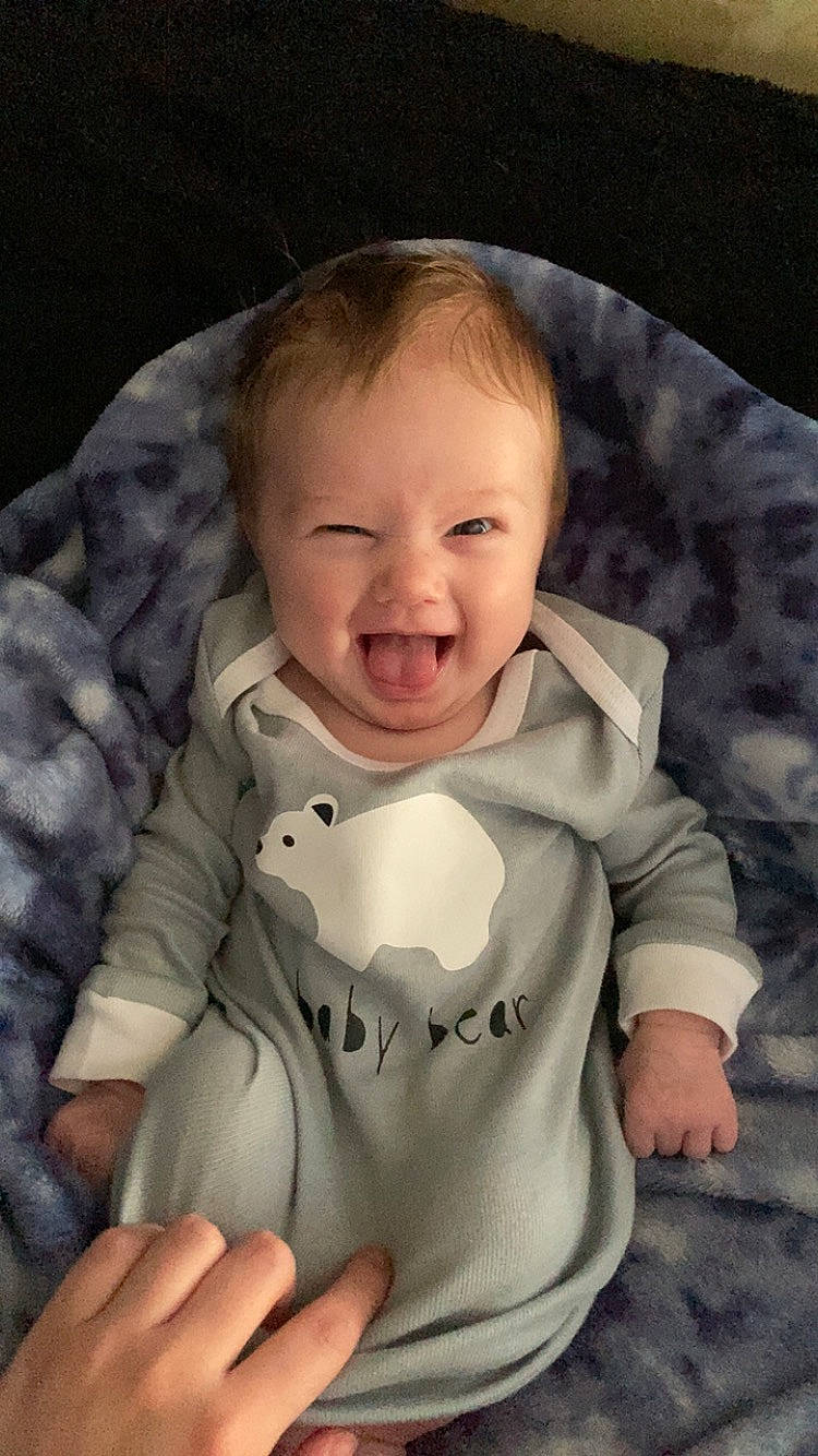 Justice is registered to the contest to win money with this photo: baby, baby_products, baby_toddler_clothing, cheek, child, comfort, eye, eyebrow, finger, flash_photography, gesture, happy, iris, lip, nose, person, skin, sleeve, smile, thumb