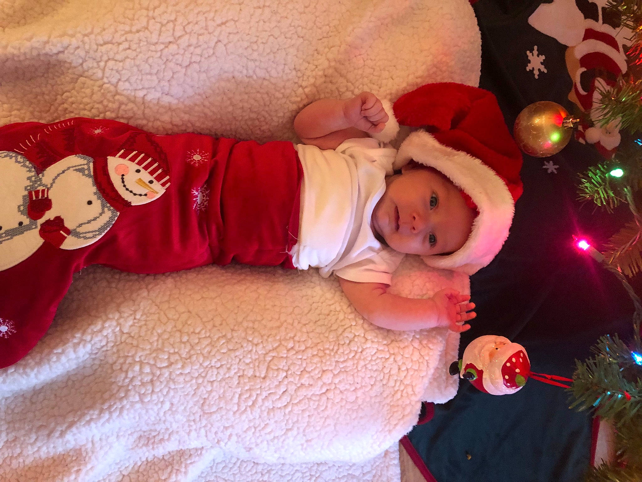 Jocelyn joined the competition — help win amazing prizes! baby, baby_toddler_clothing, child, christmas, christmas_eve, christmas_tree, event, facial_expression, happy, hat, head, headwear, holiday, lap, person, pink, red, sleeve, smile, sock