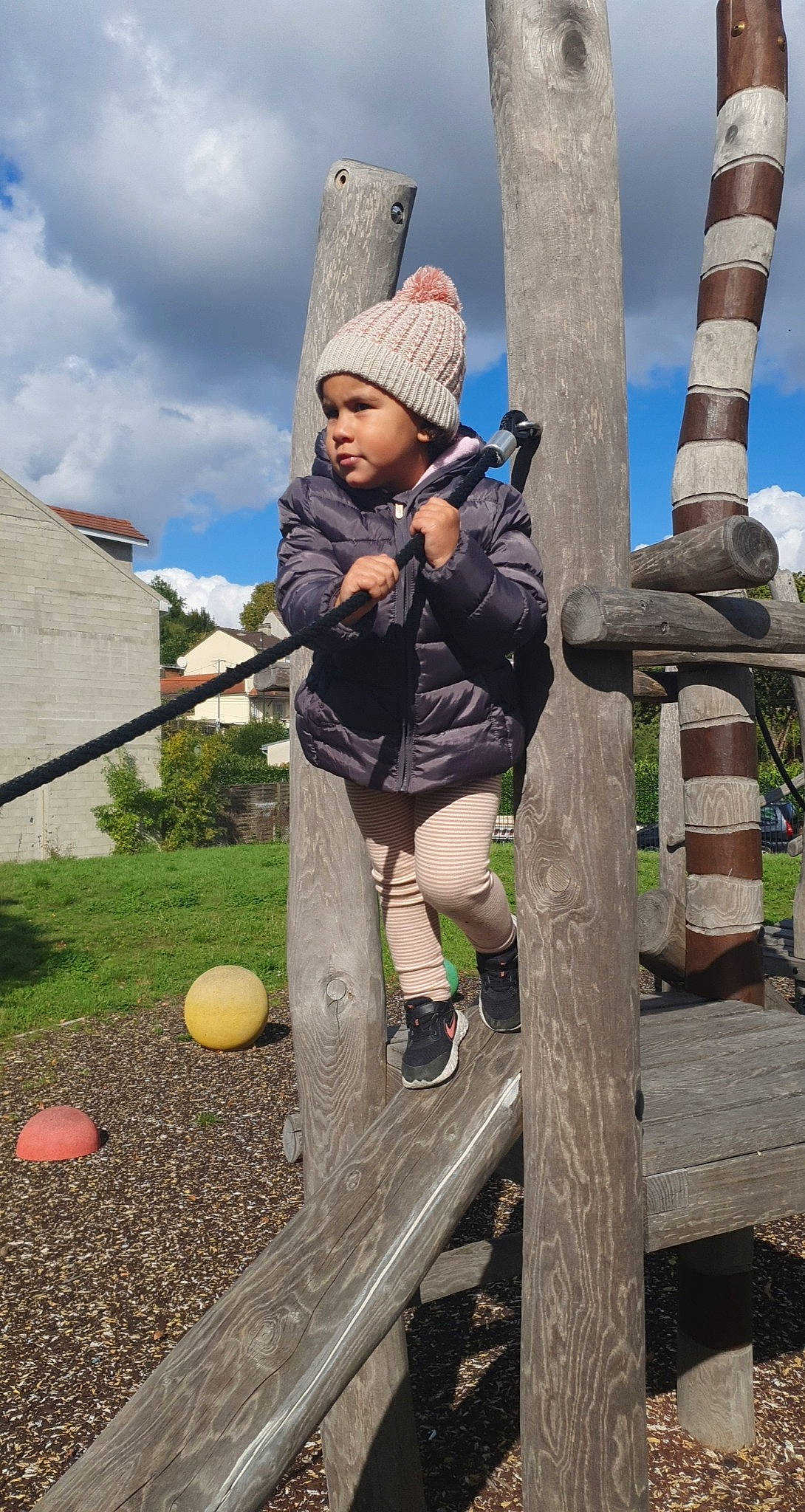 Melina a rejoint le concours — aidez-le/la à gagner de superbes lots ! baby, baby_toddler_clothing, balance, ball, beanie, bonnet, headwear, human_settlement, outdoor_play_equipment, outdoor_shoe, person, play, playground, public_space, shoe, sneakers, swing, toddler, yard