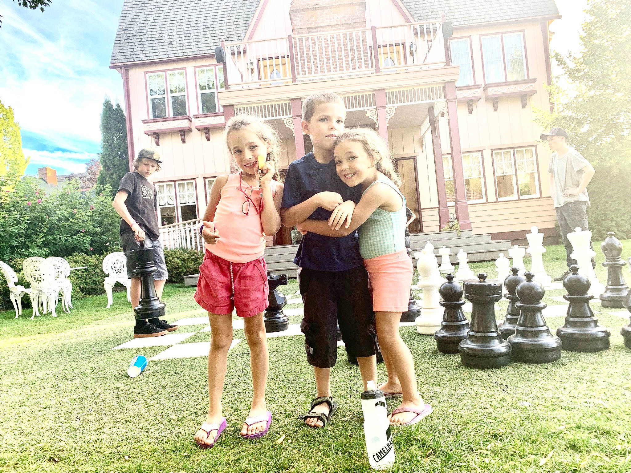 Daniella is registered to the contest to win money with this photo: child, family, fun, games, grass, happy, headwear, home, house, joy, lawn, leisure, people, person, photograph, photography, play, recreation, snapshot, summer