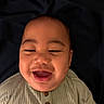 Tamasa joined the competition — help win amazing prizes! baby, infant, child, portrait, smiling, laughing, happy, face, eyes, mouth, close_up, indoor, bed, bedding, dark_background, warm_lighting, clothing, buttoned_shirt, ribbed_fabric, photography