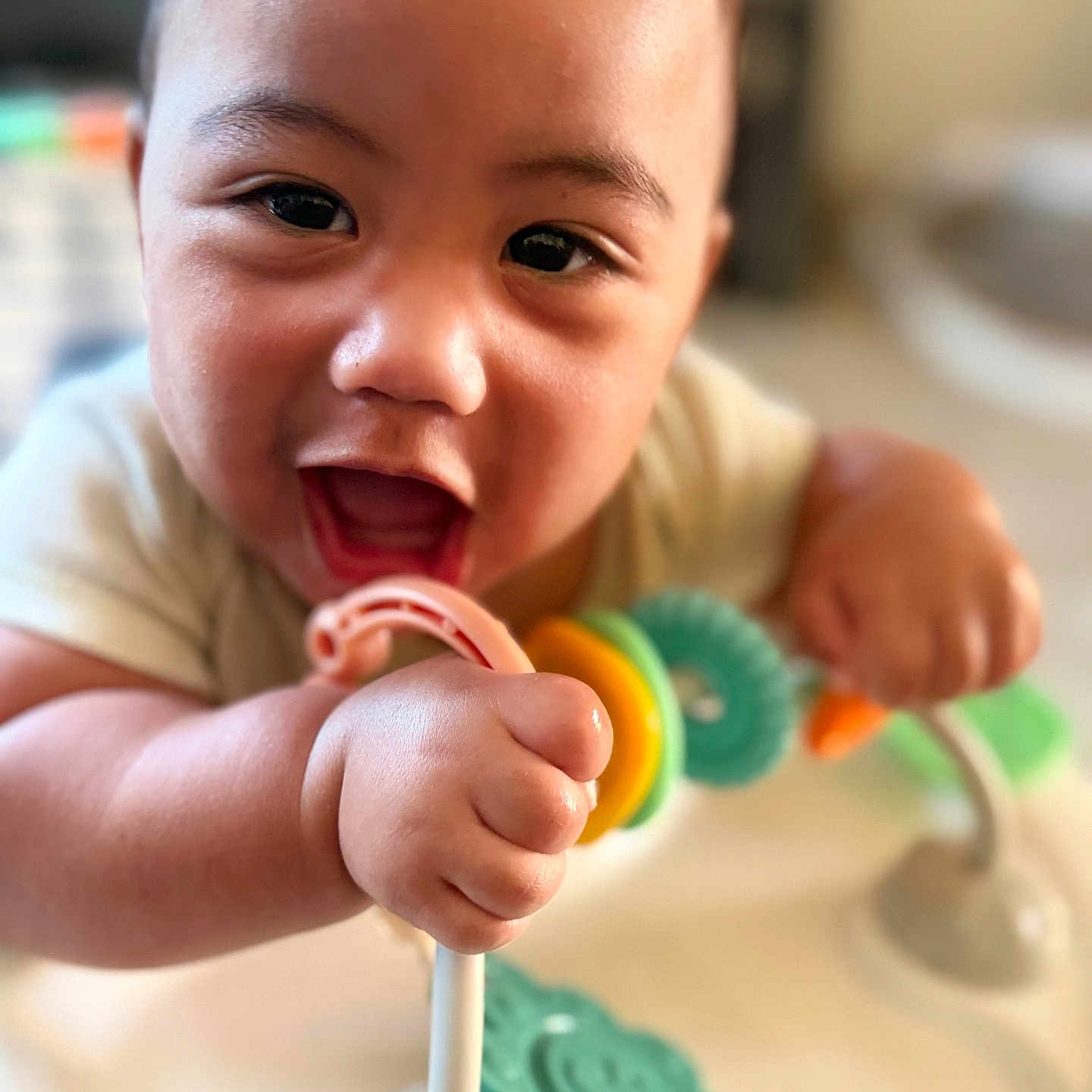 Tamasa joined the competition — help win amazing prizes! baby, child, smiling, toy, hand, face, indoor, playtime, happy, closeup, infant, person, colorful, cute, expression, skin, head, young, holding, focus