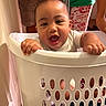 Tamasa is registered to the contest to win money with this photo: adult, baby, basket, candid, child, close_up, green_shirt, hands, happy, home, household, indoor, infant, laughing, laundry_basket, playful, portrait, smiling, warm_lighting, white_shirt
