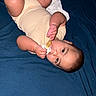 Tamasa is registered to the contest to win money with this photo: baby, pacifier, blanket, blue_blanket, yellow_onesie, infant, lying_down, hand, face, skin, curious, clothing, soft_texture, child, indoors, bed, resting, cute, sleepwear, newborn