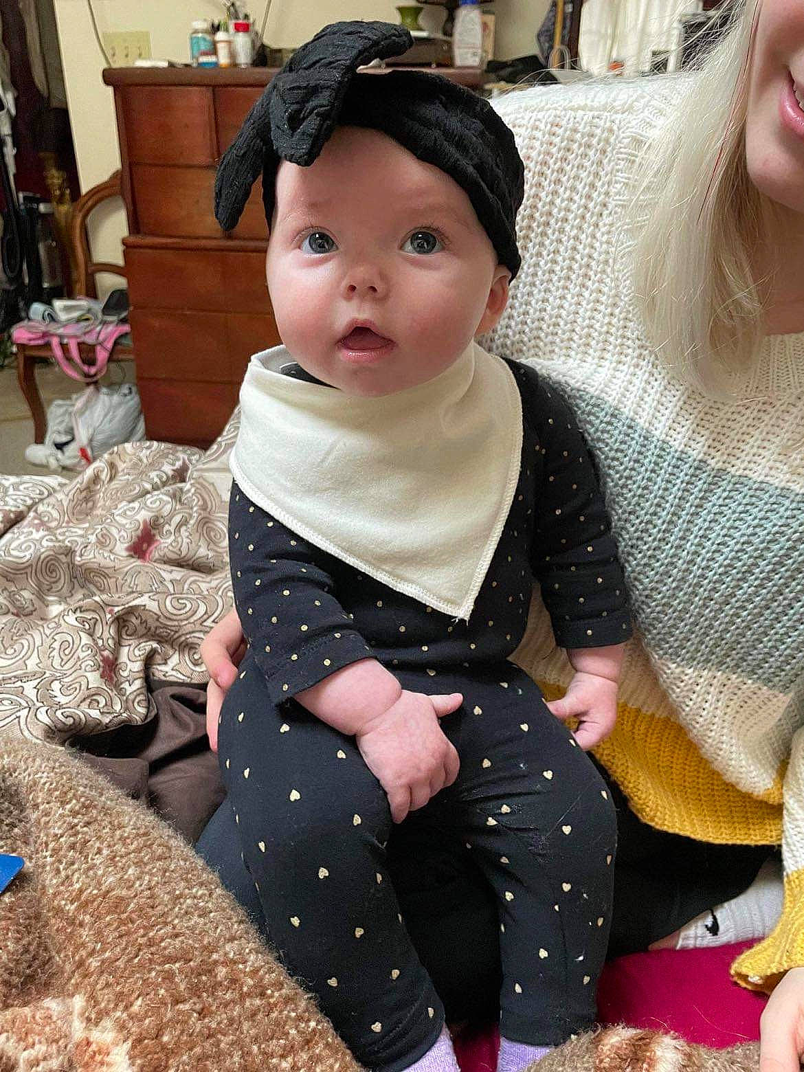 June is registered to the contest to win money with this photo: baby, baby_toddler_clothing, cheek, child, cool, costume, design, eyelash, fashion_accessory, fun, happy, headwear, jewellery, neck, pattern, person, polka_dot, sitting, skin, sleeve