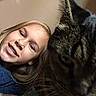 child, girl, smile, braces, cat, tabby_cat, face, close_up, indoor, portrait, blond_hair, pet, animal, feline, young, happy, cute, companion, friendship, casual_clothing
